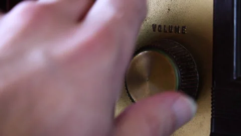 Hand Turns Volume Knob Down on Vintage Radio - Close Up Stock Footage 153490368