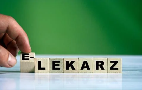 Hand turns the wooden cube and changes the polish word LEKARZ (english doctor Stock Photos