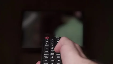 Hand with TV remote control. Changing channels Video stock 305854526