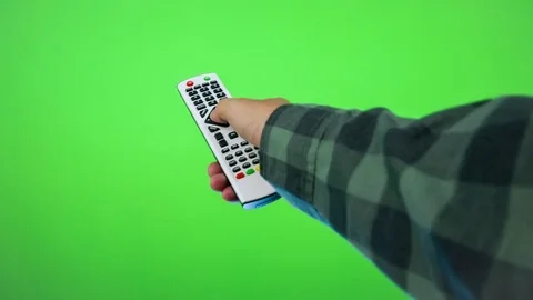 Hand with tv remote control isolated on green screen background Видео 83769332