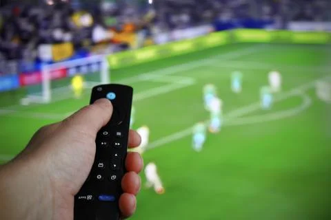 Hand with TV remote control Stockfoto's