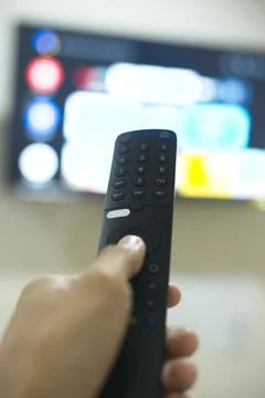 Hand with TV remote control, switching TV series from streaming service pla.. Stock Photos