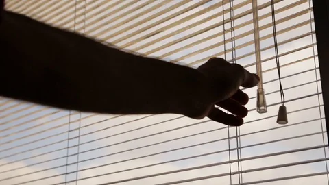 Hand twists blinds to a shut Stock Footage 87831708