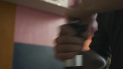 Hand twists the handle of a mechanical coffee grinder in the kitchen at home Stock Footage 171154448