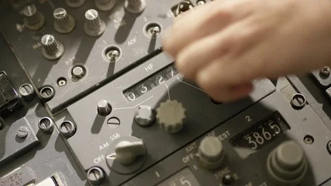 Hand twists a knob to adjust numbers on cockpit display Stock Footage 82841655