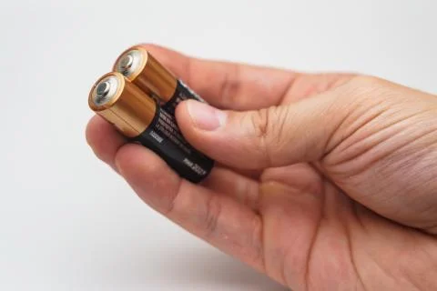 Hand with  two batteries Foto stock