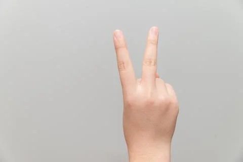 Hand with two fingers up Stock Photos