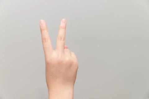 Hand with two fingers up Stock Photos