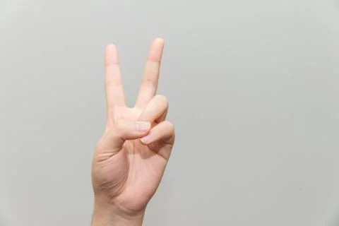 Hand with two fingers up Stock Photos