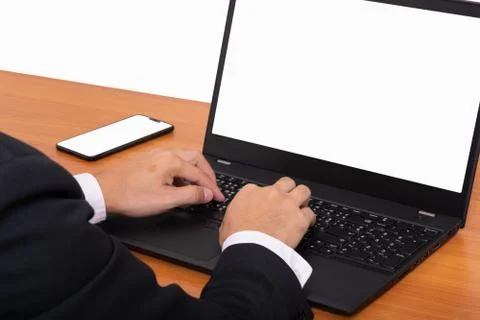 Hand tying labtop computer with smartphone on table Stock Photos