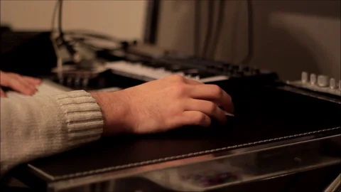 Hand typing and clicking mouse near music equipment Video stock 71663971