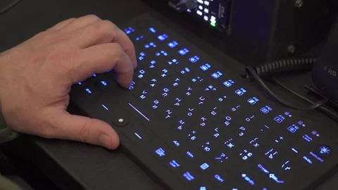 Hand typing on blue backlit keyboard in dark workspace Stock Footage 321680352