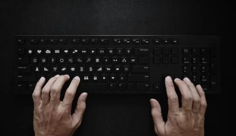 Hand typing on computer keyboard, with application icons on button Stock Photos