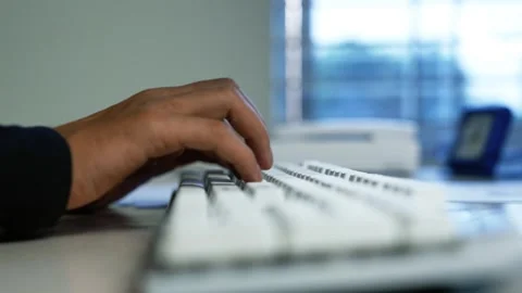 Hand Typing on Computer Keyboard in Office, Close-up of a person's hand typ.. Video stock 345119151