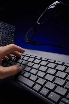 Hand typing on computer keyboard Foto stock