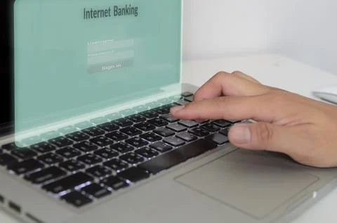 Hand is typing the computer keyboard on virtual screen internet banking.Bus.. Stock Photos
