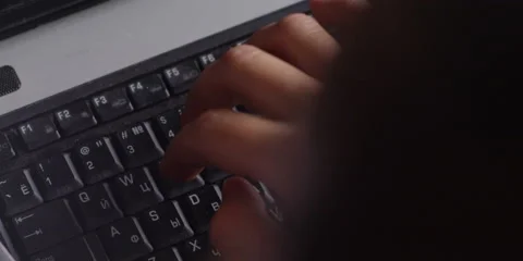 Hand Typing Computer Keys Over The Shoulder Close Up Vidéo 57250034