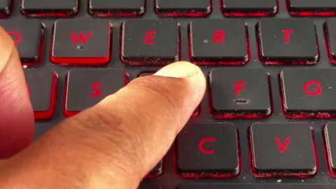 Hand typing on "D" on illuminated laptop keyboard, perfect for computing, Stock Footage 334637879