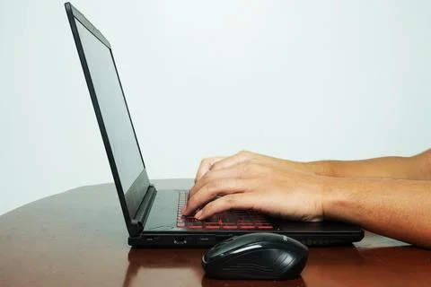 Hand typing on keyboard at the table during working from home. Stock Photos