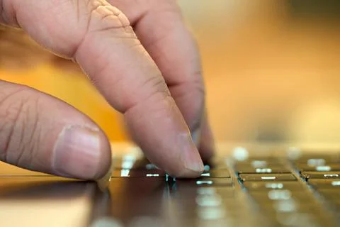 Hand typing on a keyboard while working Foto stock