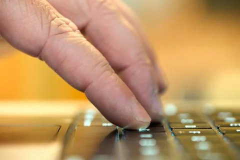 Hand typing on keyboard in a workspace Stock Photos