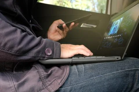 Hand typing on a laptop computer at a desk in close-up Stock Photos