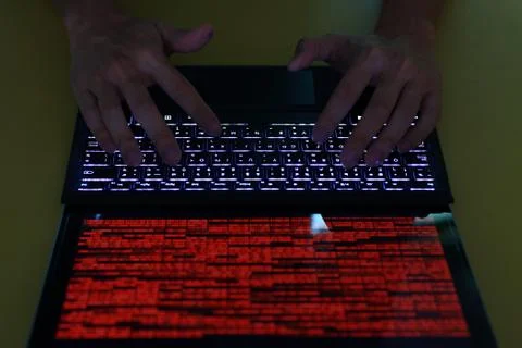 Hand typing on Laptop computer Keyboard top view. screen displaying red lines Stock Photos