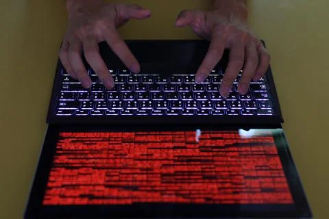 Hand typing on Laptop computer Keyboard top view. screen displaying red lines Stock Photos