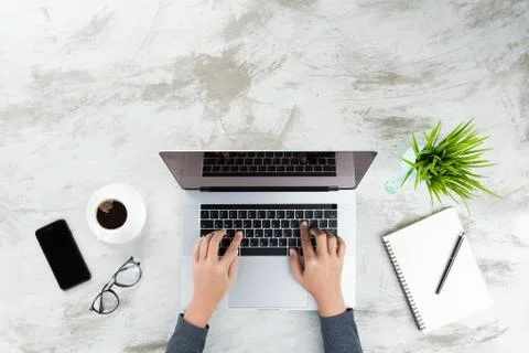 Hand typing on laptop computer top view Stock Photos