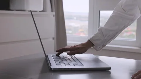 Hand typing on a laptop keyboard, a close up view. Stock Footage 276896536