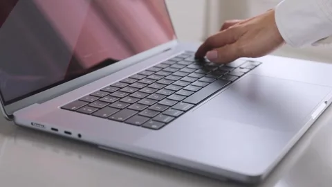 Hand typing on a laptop keyboard, a close up view. Stock Footage 276896554