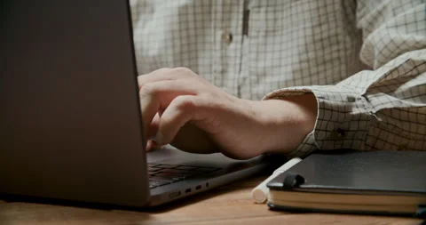 Hand Typing on Laptop Keyboard in Dim Light, Close-Up Stock Footage 308357280
