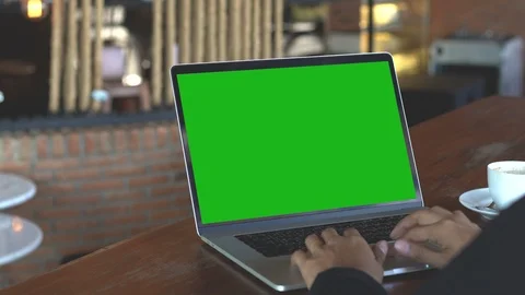 Hand typing on laptop keyboard showing green screen, 4k Stock Footage 87475428