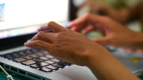 A hand typing on a laptop keyboard at work Stockbeeldmateriaal 239763393
