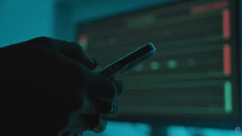 Hand typing on mobile phone in dark studio or control room with audio equipment Видео 331308142