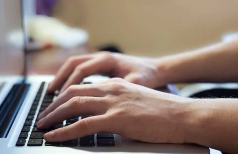 Hand typing on notebook keyboard Stock Photos