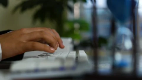 Hand typing on white keyboard, Close-up of a person's hand typing on a whit.. Vídeo Stock 329177167
