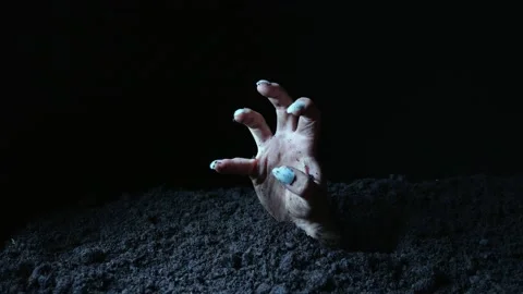 The hand of the undead makes gestures and points to something after emerging  Stock Footage 214441570