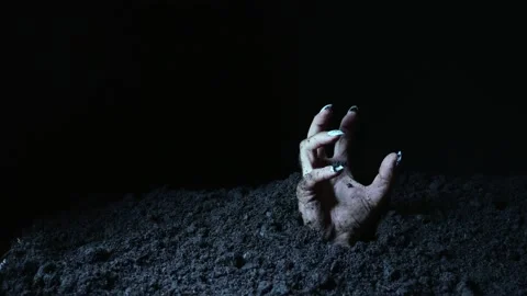 The hand of the undead makes gestures and points to something after emerging  Stock Footage 214792243
