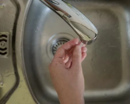 Hand Under Running Water at Kitchen Sink, Washing Hands Faucet Close up Stock Photos