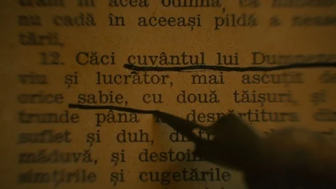 Hand underlining words of an old Romanian Bible Stock Footage 86194438