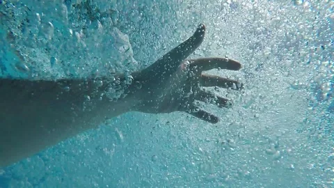 Hand underwater submerged between bubbles slowly rising to the surface Video stock 127068932