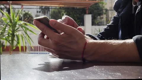 The hand of an unknown man holds a pen and taps his finger on the screen Stock Footage 230105591