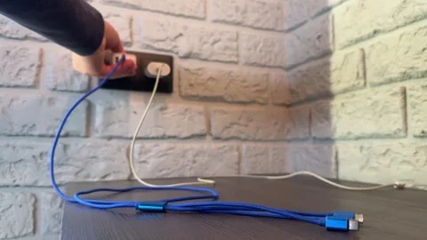 The hand of an unknown person pulls out a power supply with a display from a Stock Footage 270411918