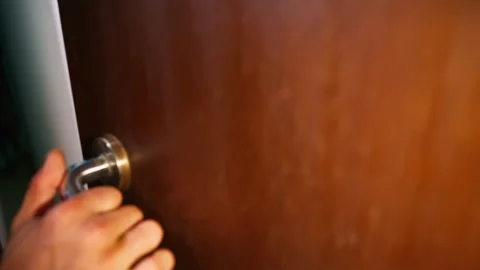 Hand unlatches apartment gate using gentle pressure Stock Footage 311148396