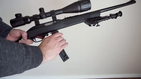 A Hand Unloading a  Semi-Automatic Rifle Clip Stock Footage 98379773
