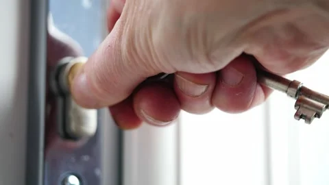 Hand unlocking door with key close up shot Stock Footage 313150682