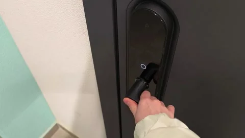 Hand unlocking smart door lock using finger authentication on electronic ac.. Stock Footage 330773956