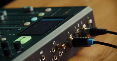 Hand unplugging audio cable from professional sound mixer Video stock 316247730
