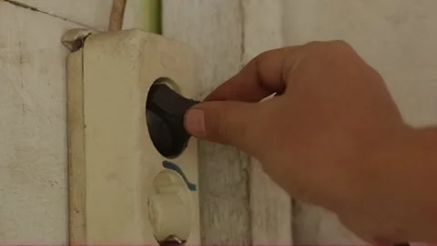 Hand unplugging electrical plug from old wall socket close-up Video stock 320128105